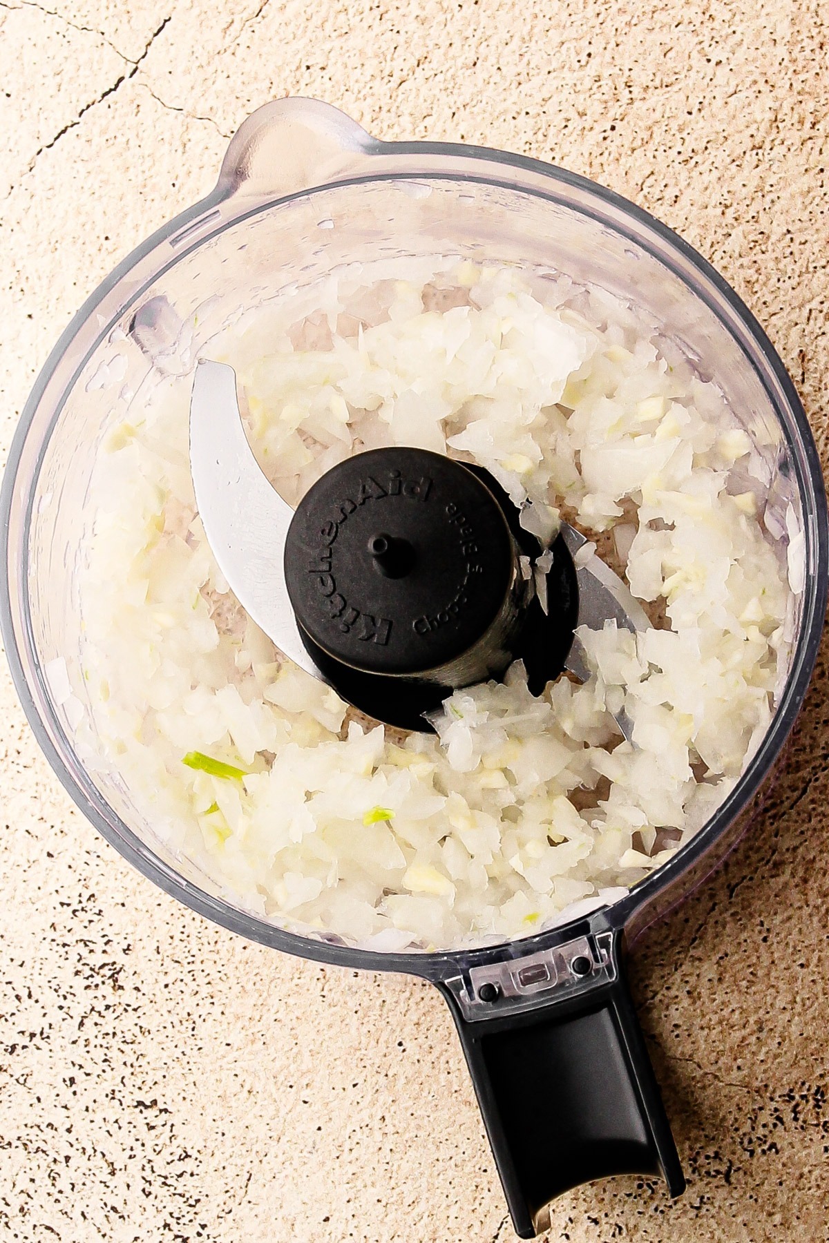 Chopped onion in a mini chopper.