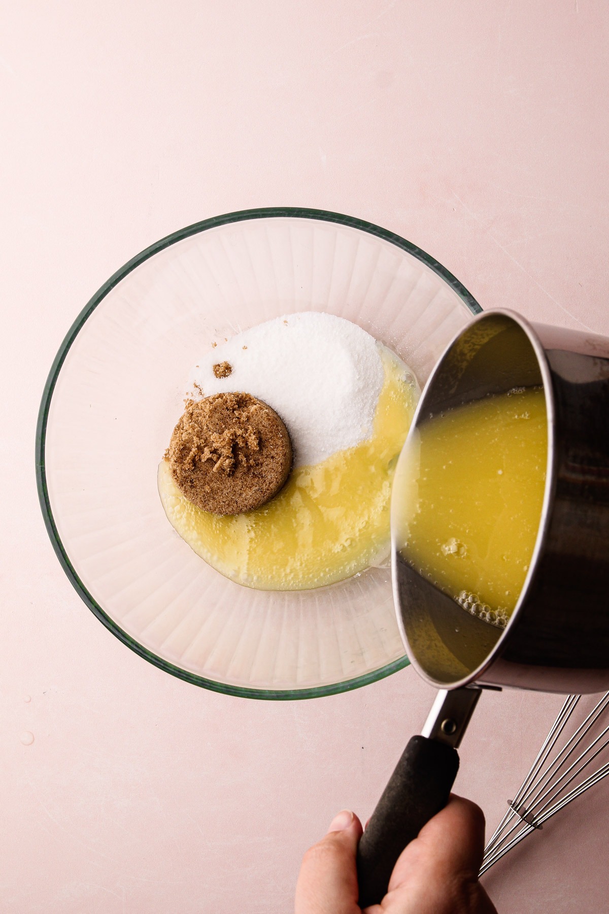 Melted butter being poured in a bowl for chocolate chip cookies.