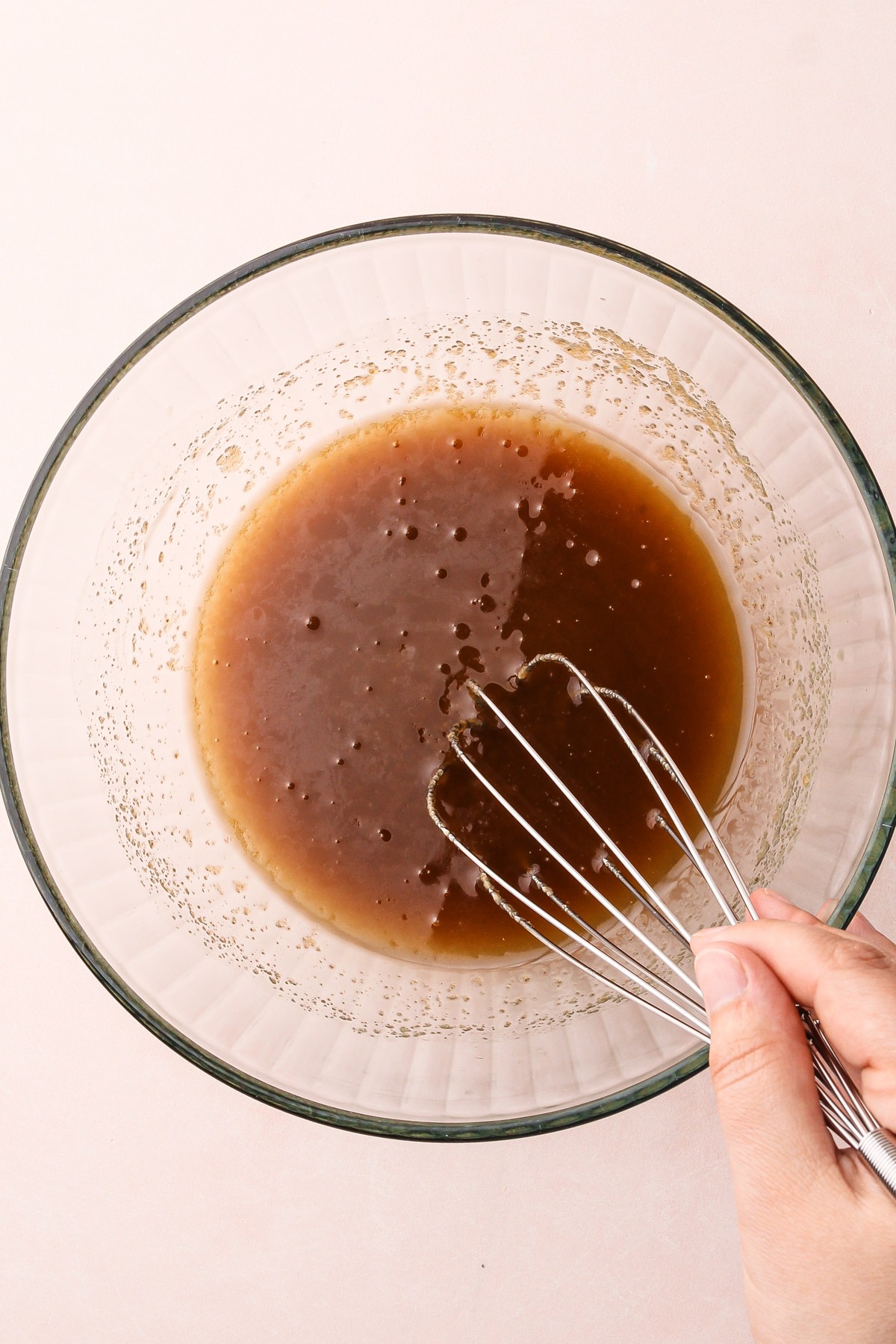 Mixing together sugar and butter in a bowl.