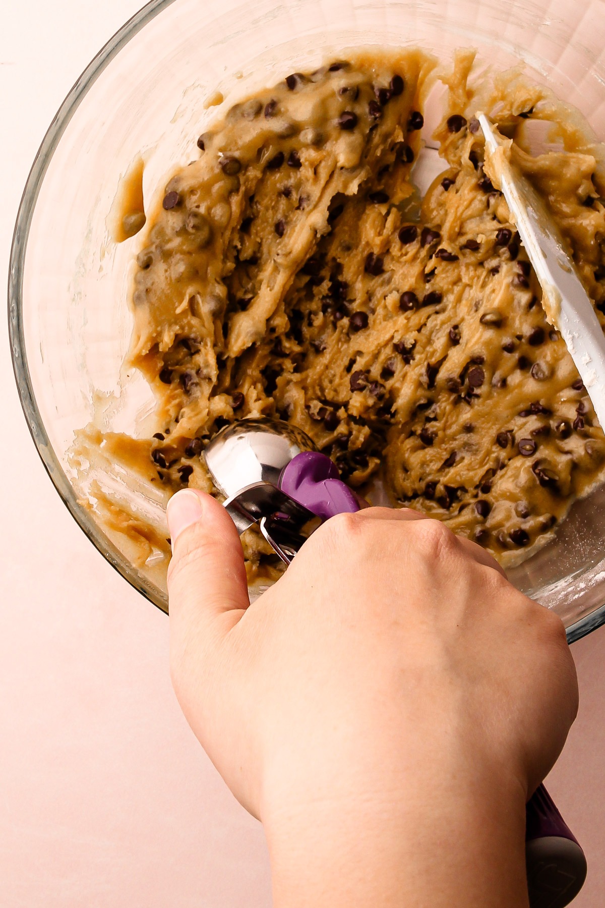 Scooping chocolate chip cookie dough.