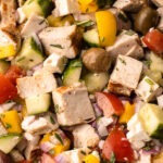 A chopped greek chicken salad fully assembled.