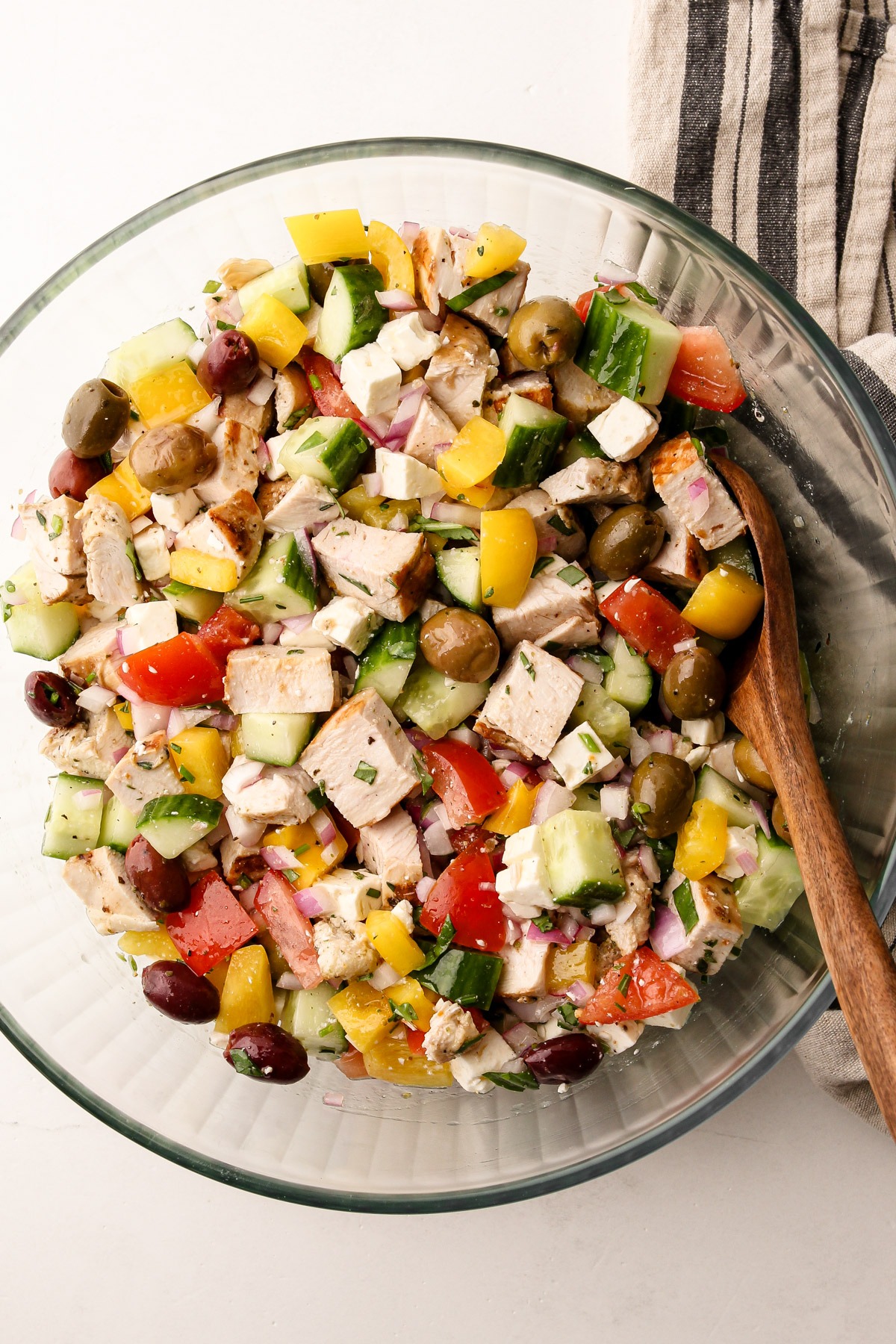 A bowl filled with a chopped greek chicken salad.