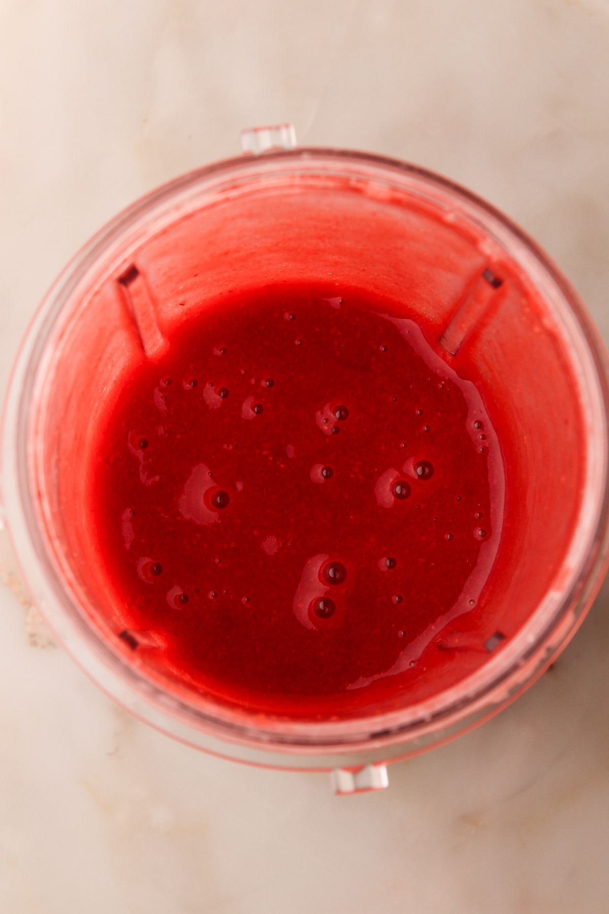 Pureed strawberries in a blender.