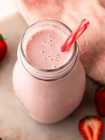 A bottle of strawberry milk made from scratch.