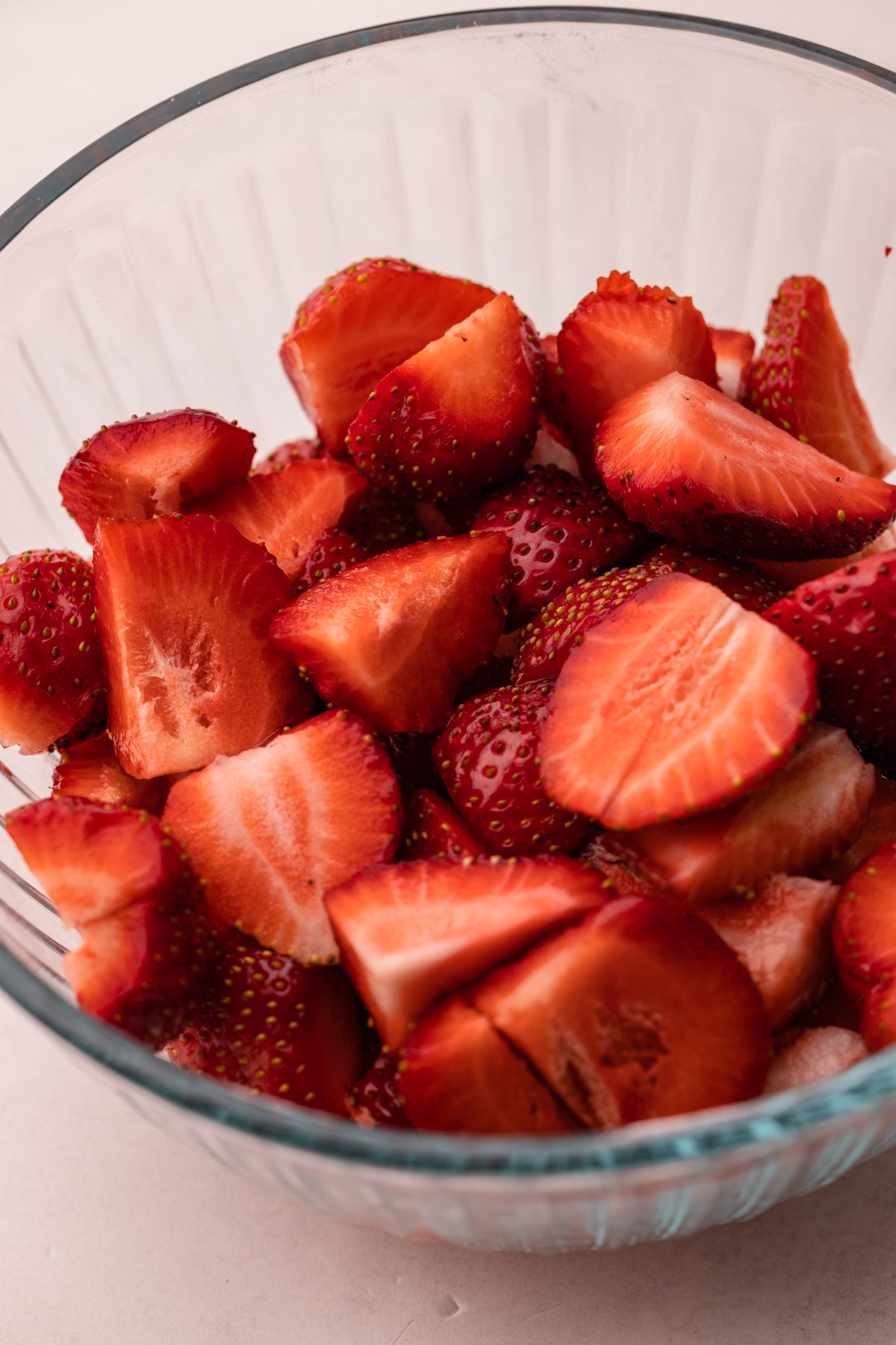 A bowl of cut fresh strawberries.