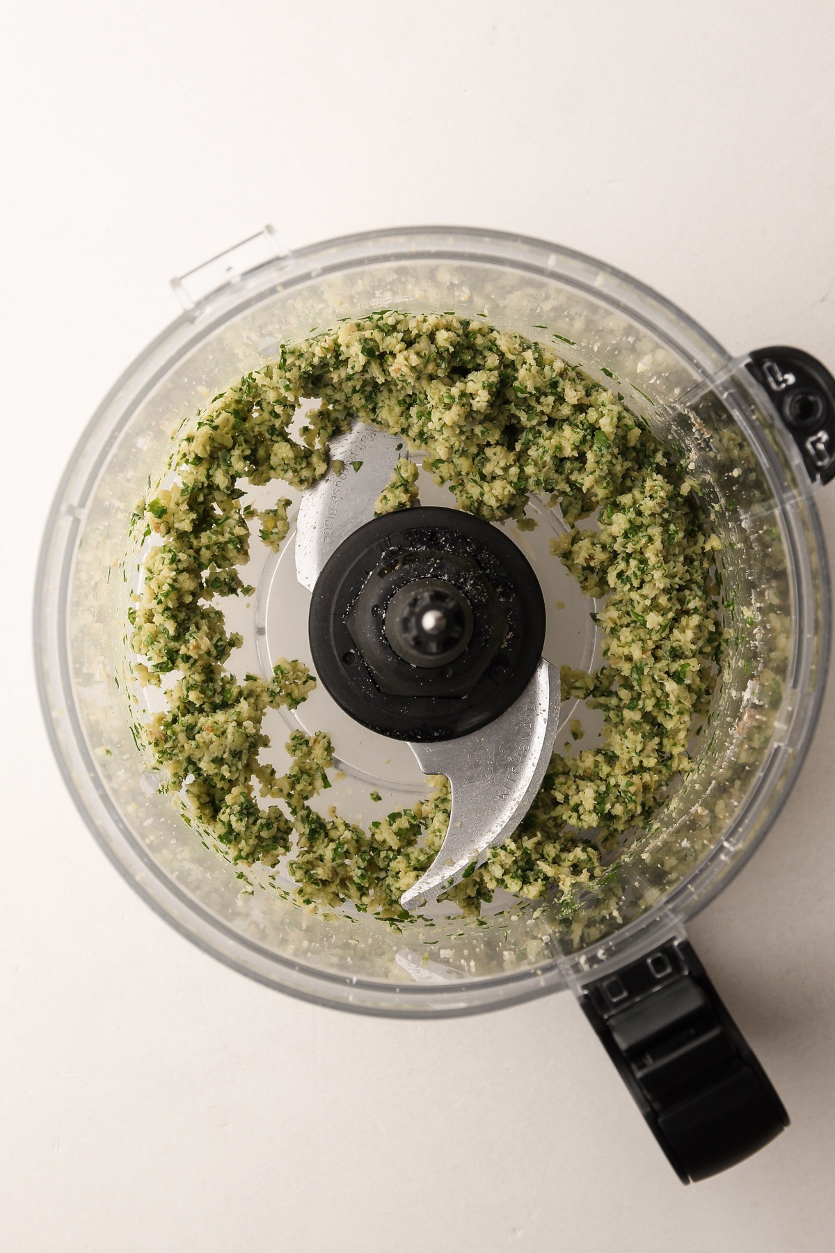 Blended garlic and herbs in a food processor.