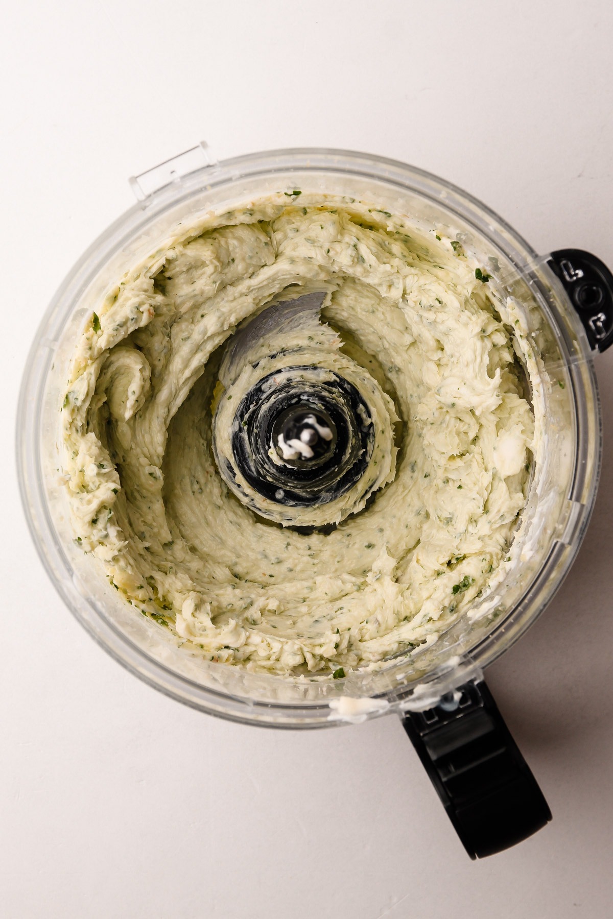 Finished garlic herb butter blended in a food processor.