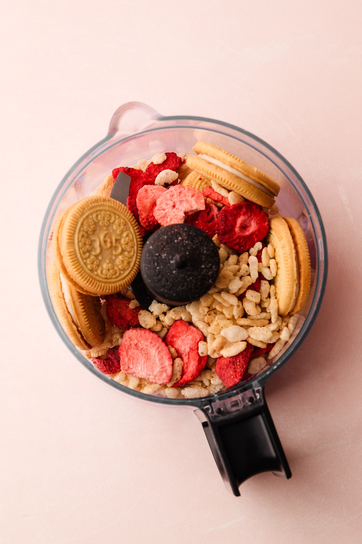 Food processor filled with ingredients for the strawberry shortcake popsicle crumb coating.