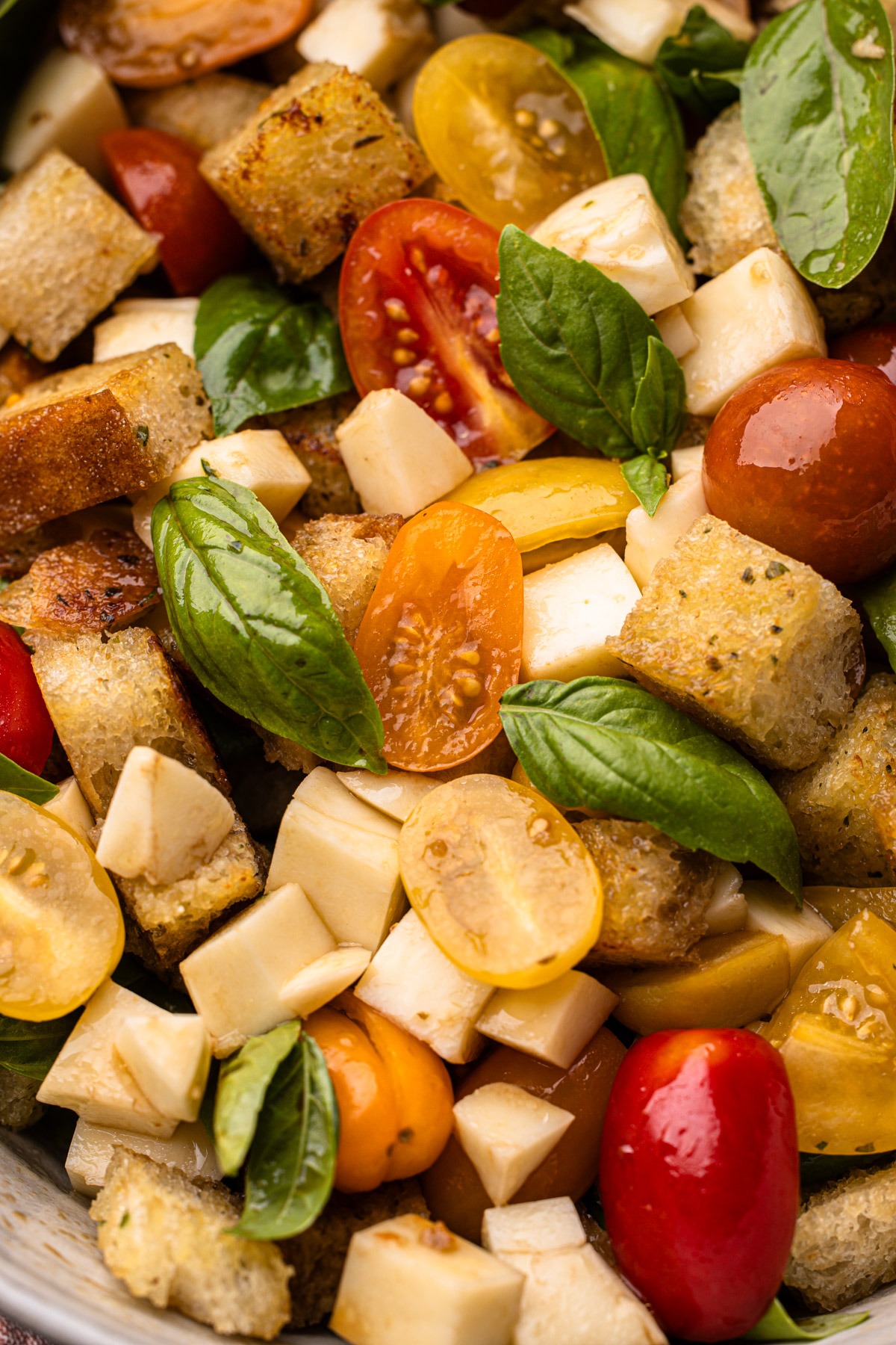 Fresh caprese panzanella salad showcasing vibrant tomatoes, basil, and garlic butter toasted bread.