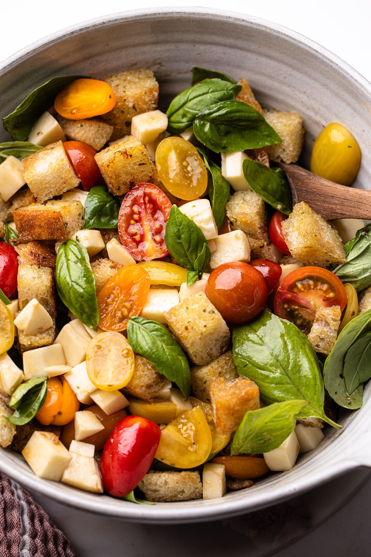 Fresh caprese panzanella salad showcasing vibrant tomatoes, basil, and garlic butter toasted bread.