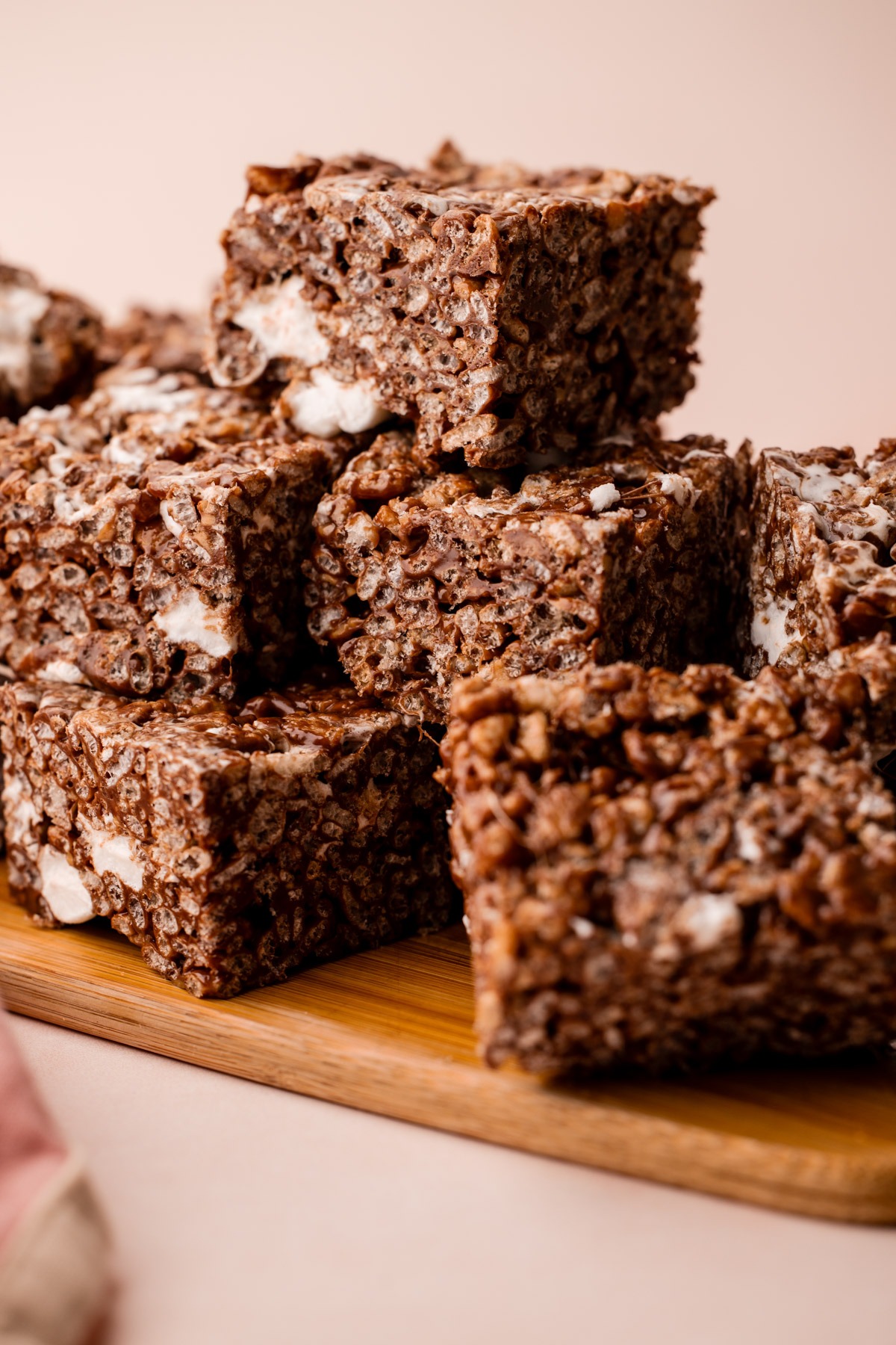 A stack of chocolate rice crispy treats showing their gooey texture.