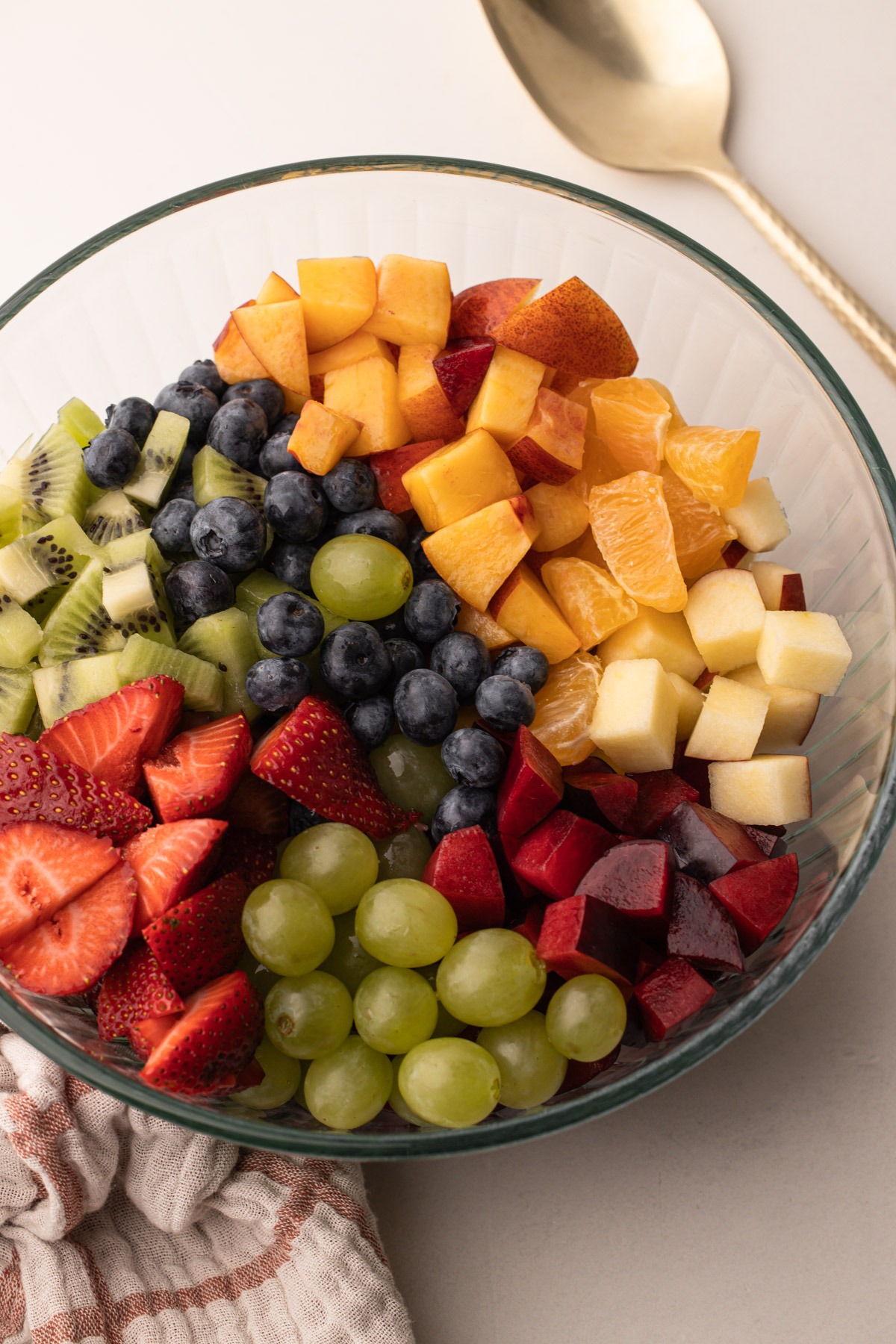 Freshly chopped fruits in a bowl, ready for a fruit salad with condensed milk.