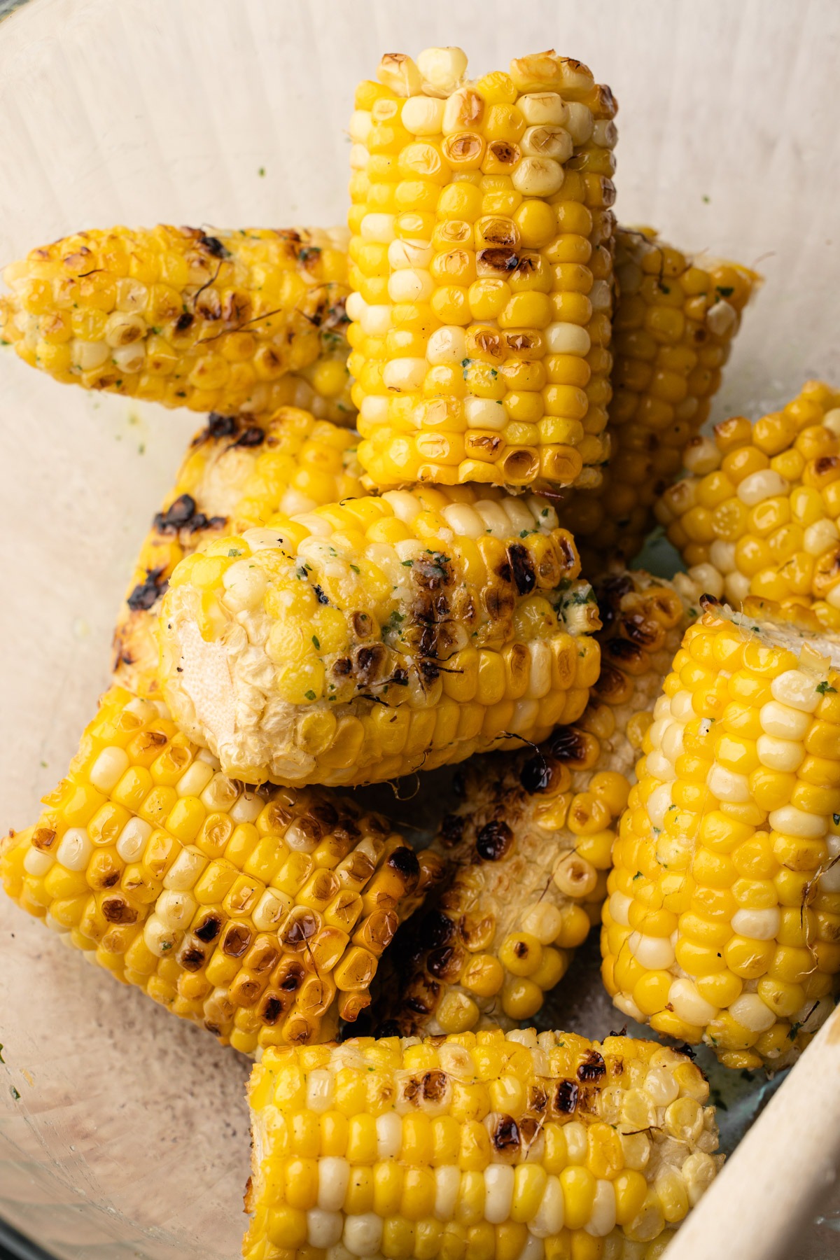 Close-up of grilled corn on the cob, showing the texture and golden color from grilling with garlic butter.