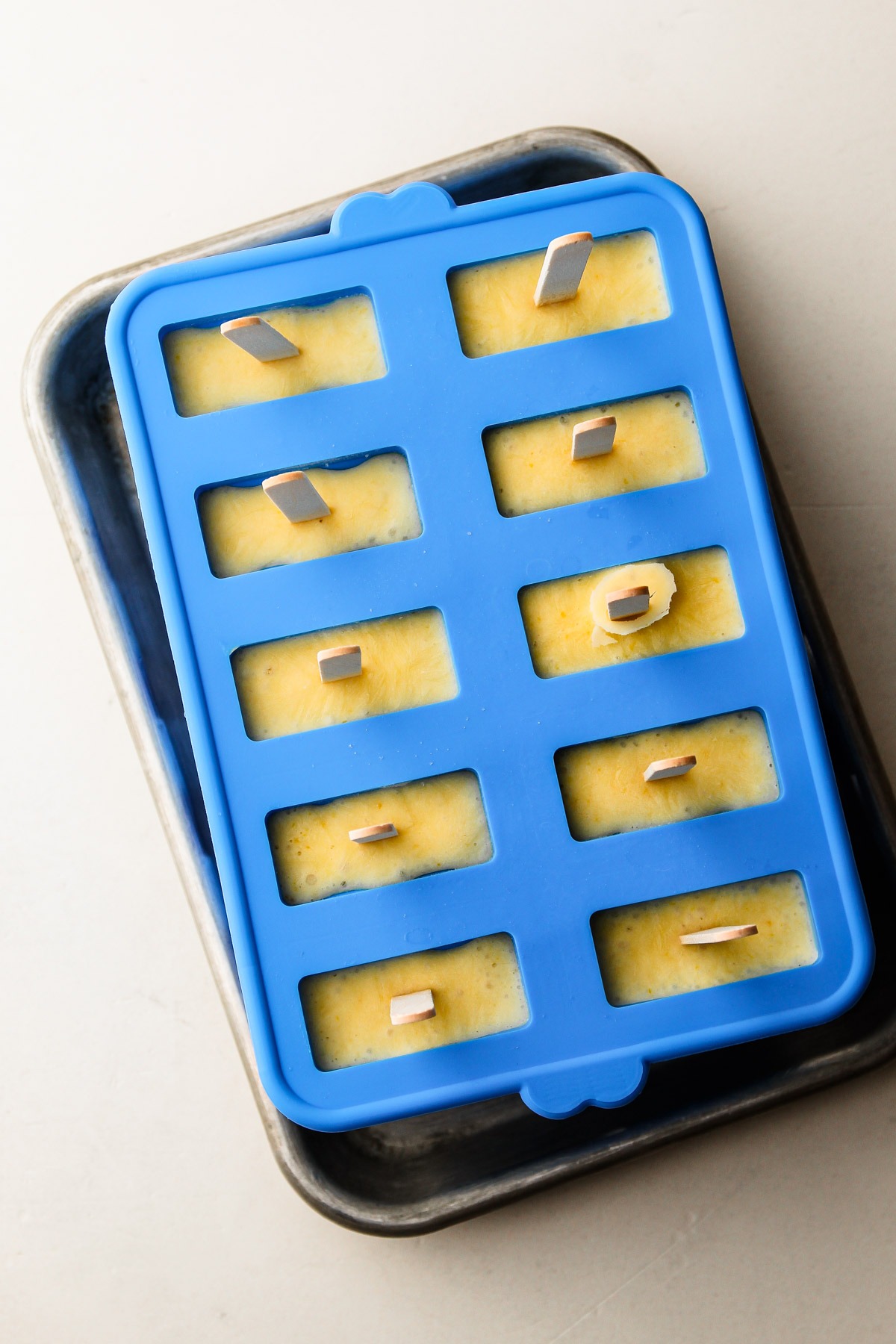 Silicone popsicle mold filled with Homemade Orange Creamsicles.