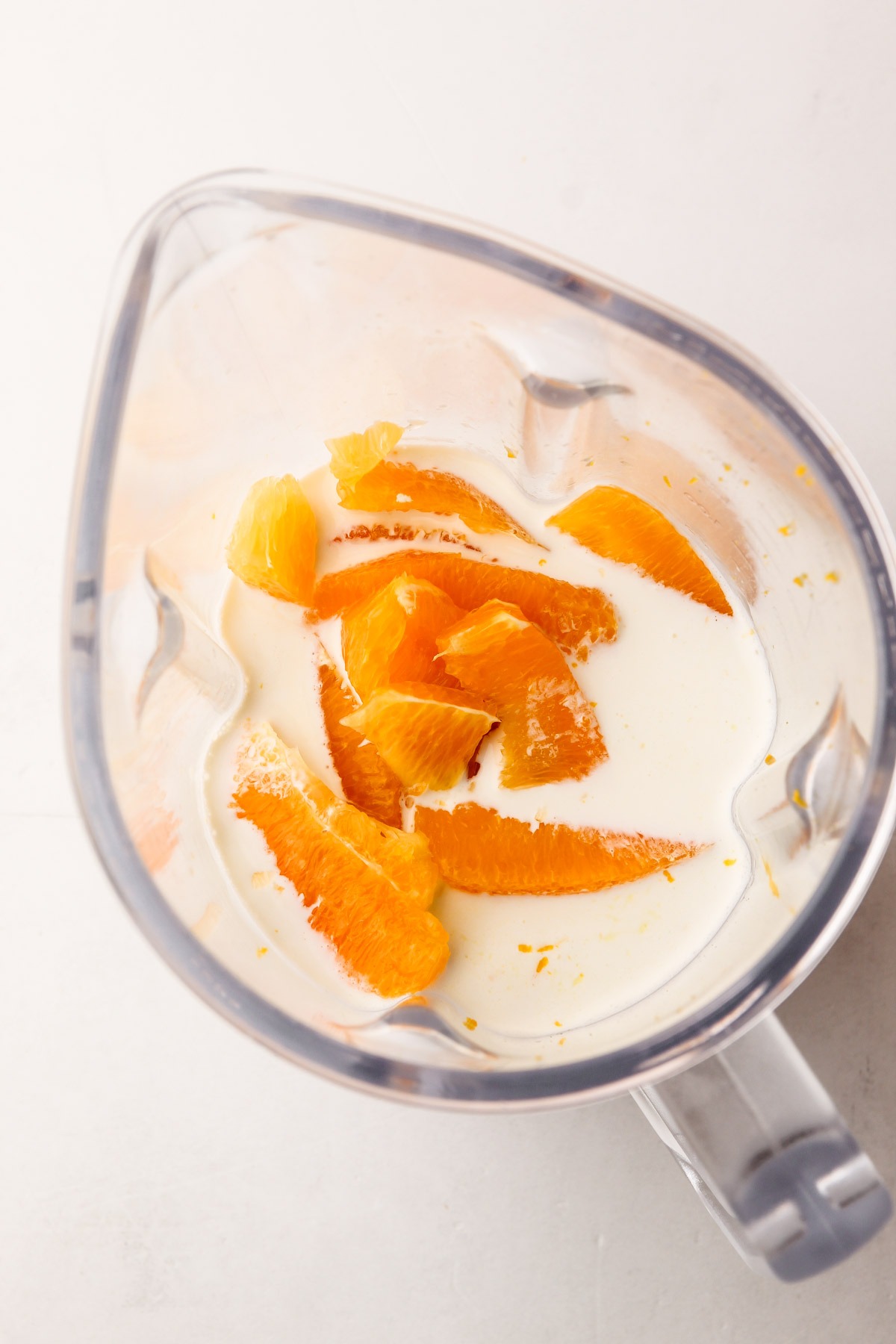 Ingredients for orange creamsicle in a blender.