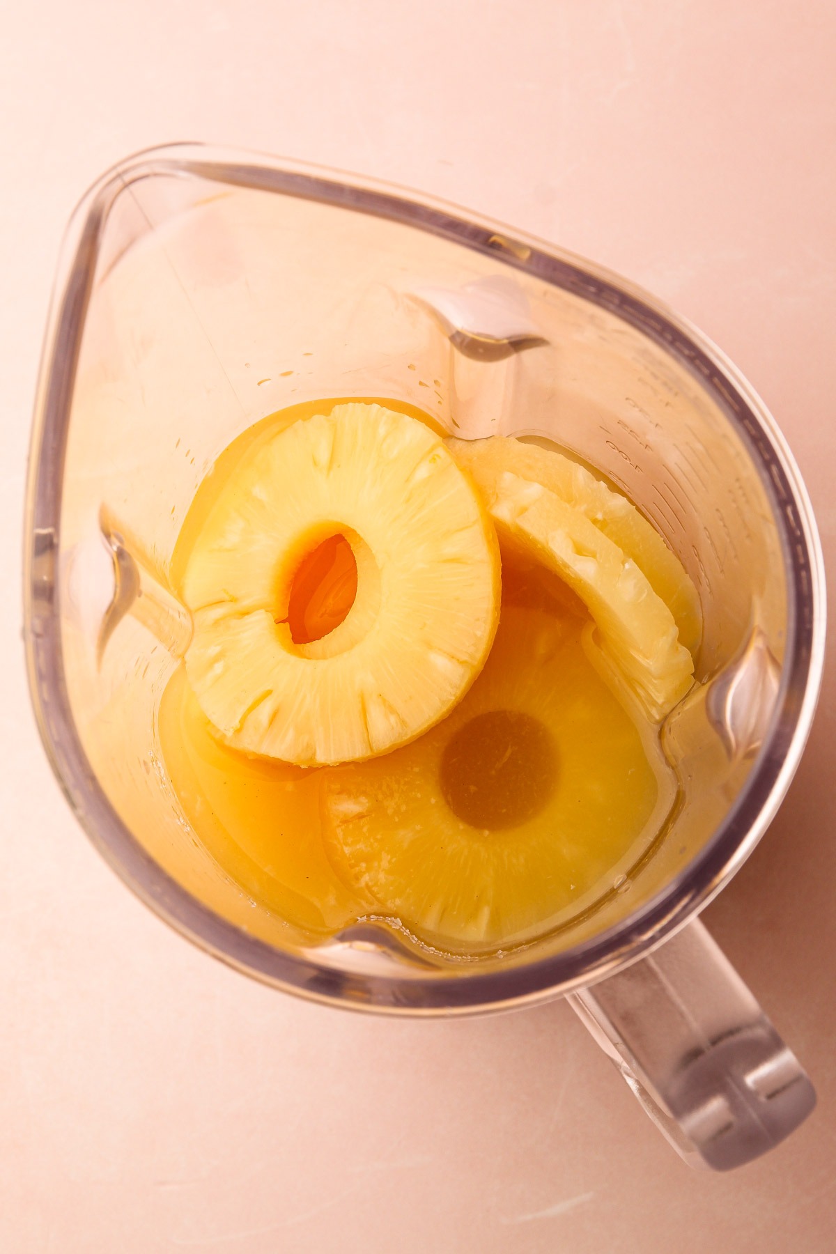 Pineapple rings in a blender ready to be pureed.