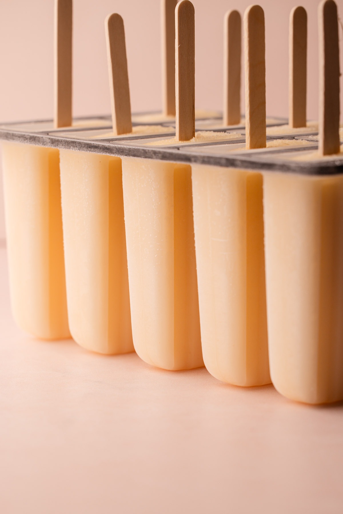 Popsicle sticks in a filled mold ready to freeze.