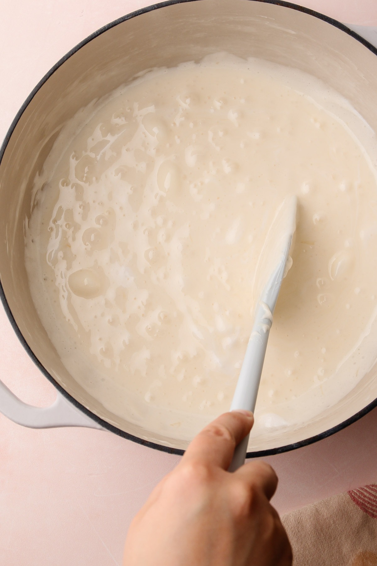 Marshmallows melting in a pot for strawberry rice crispy treats