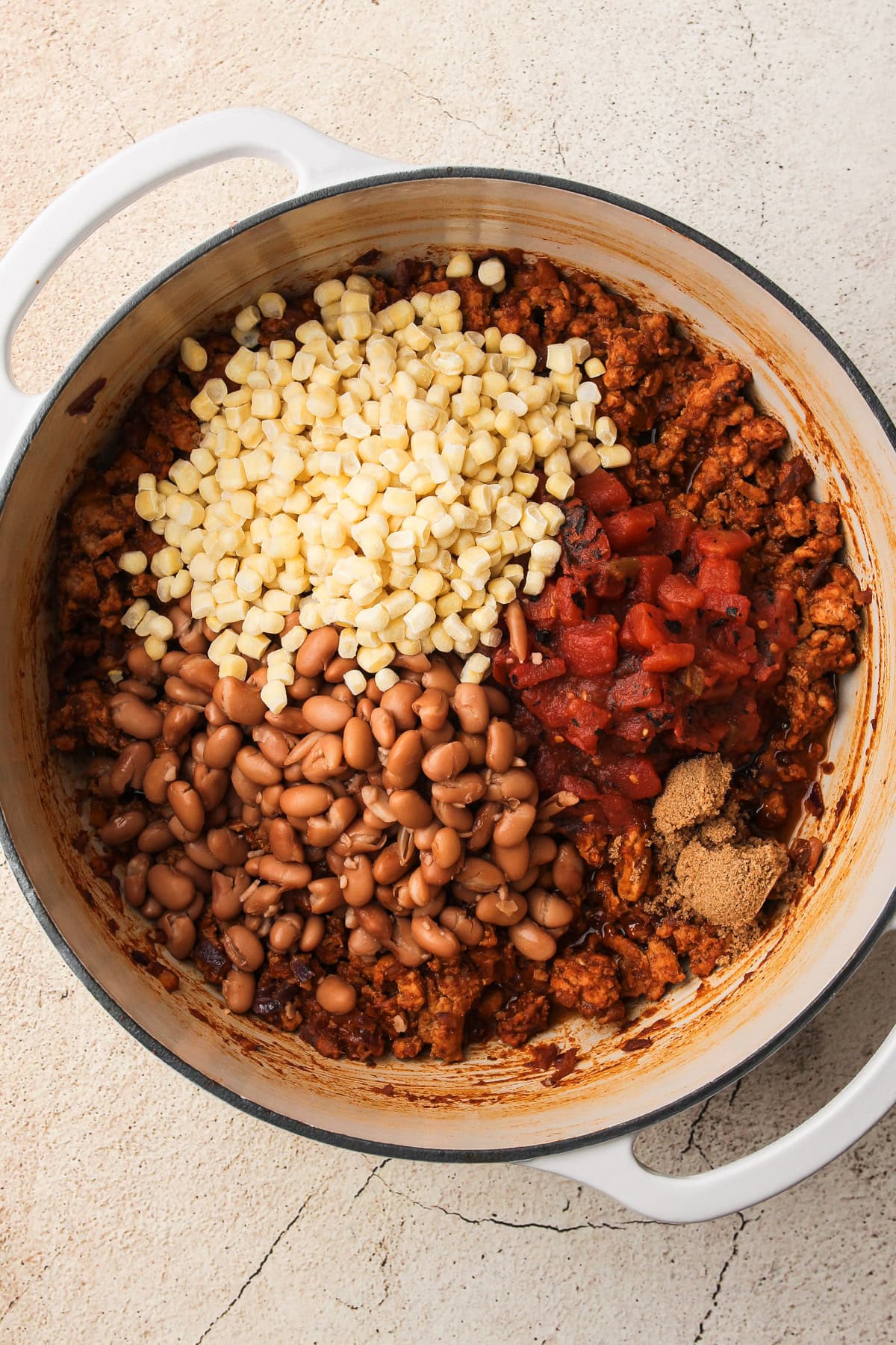 Cooked ground turkey mixed with vegetables, the starting base for a turkey chili recipe.