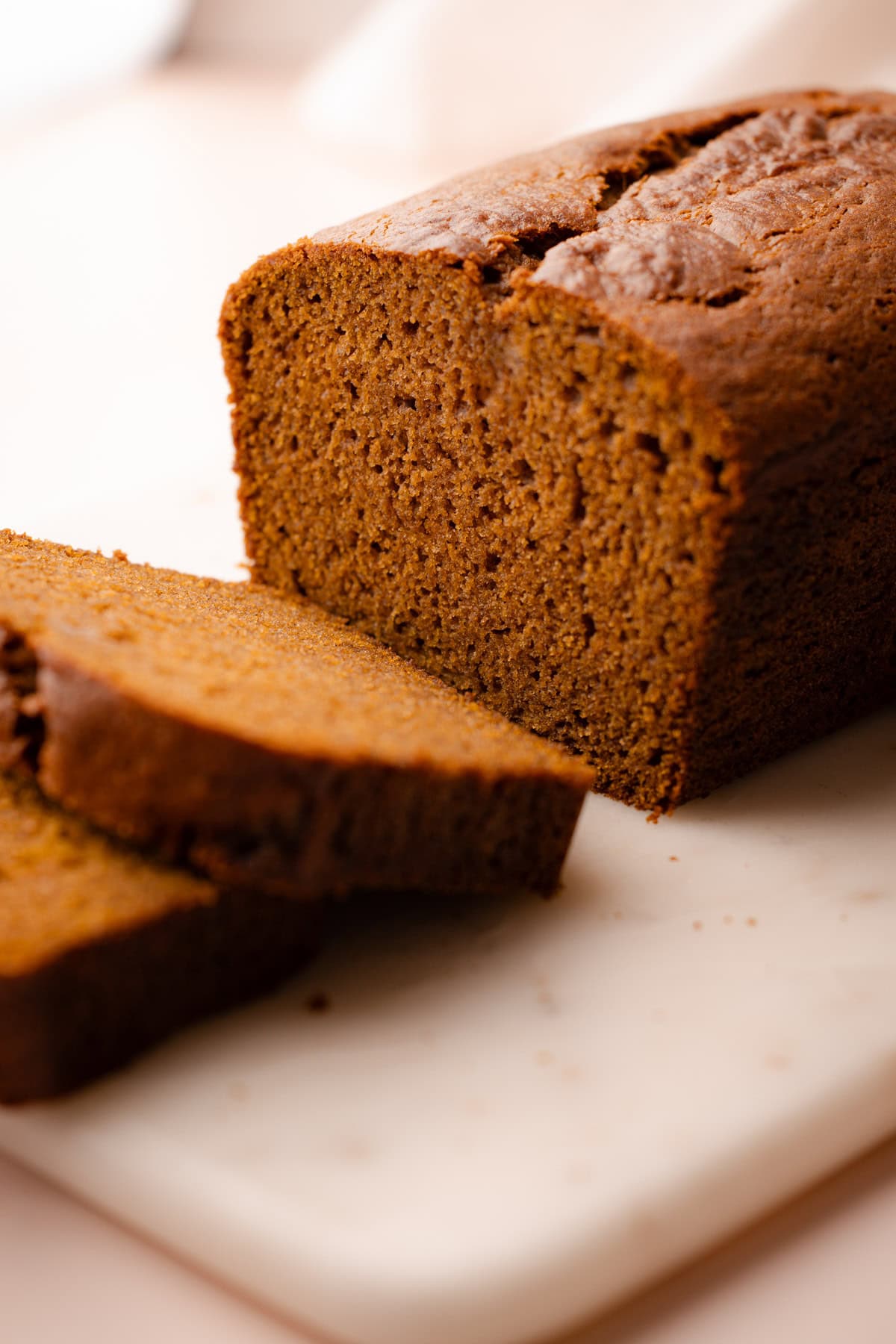 Whole wheat pumpkin bread sliced to reveal the soft, moist texture.