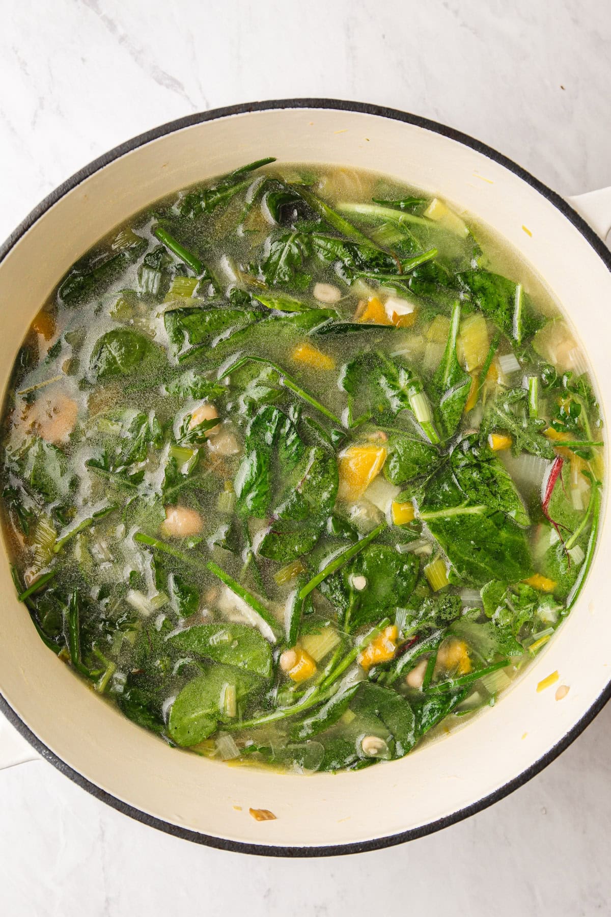 Cooking baby greens and veggies for a green godess soup.