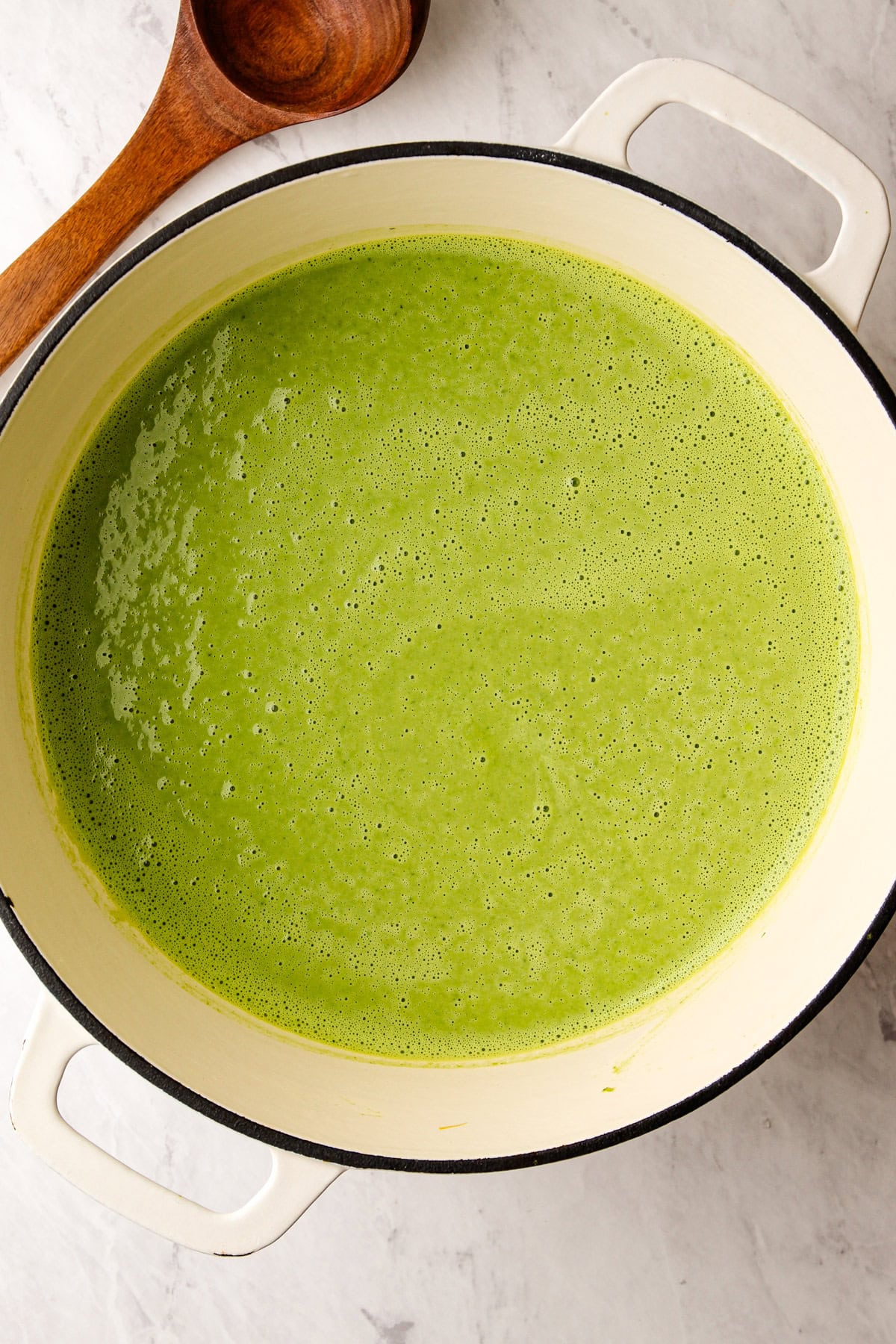 Pureed green goddess soup in a pot.