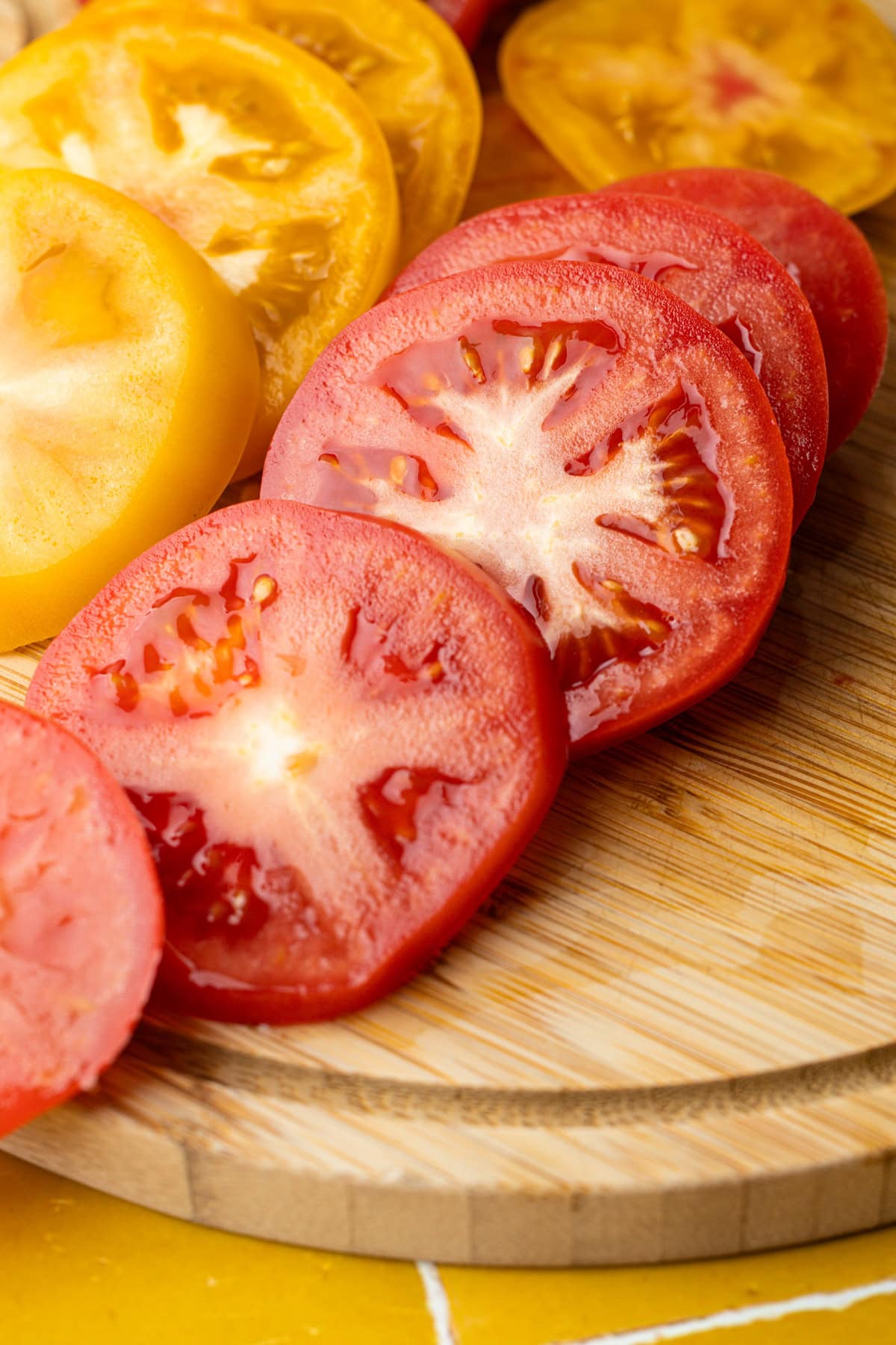 Sliced heirloom tomatoes on a cutting board.