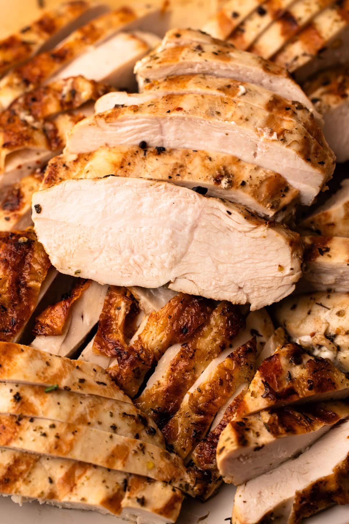 Sliced juicy chicken breasts cooked on the grill.