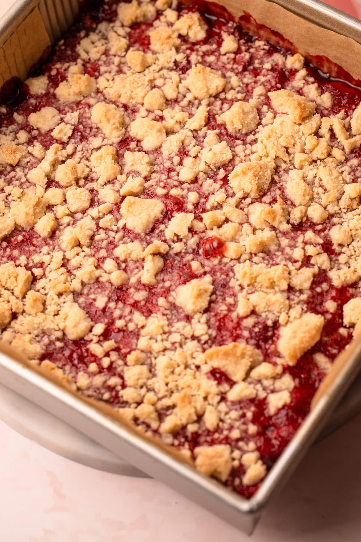 Baked and sliced strawberry crumble bars.