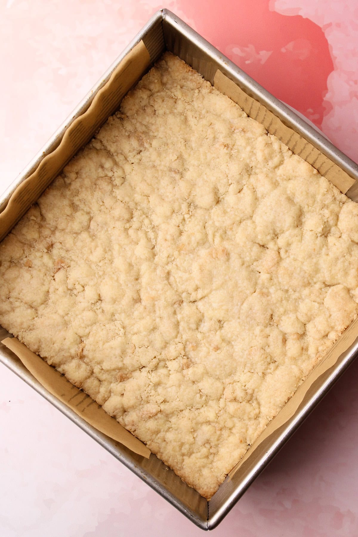 The baked crust for strawberry crumble bars.