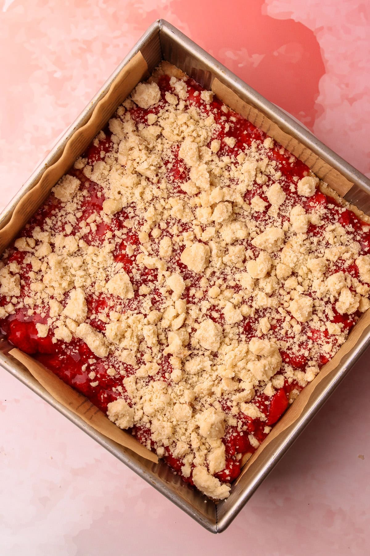 Unbaked but assembled strawberry crumb bars.