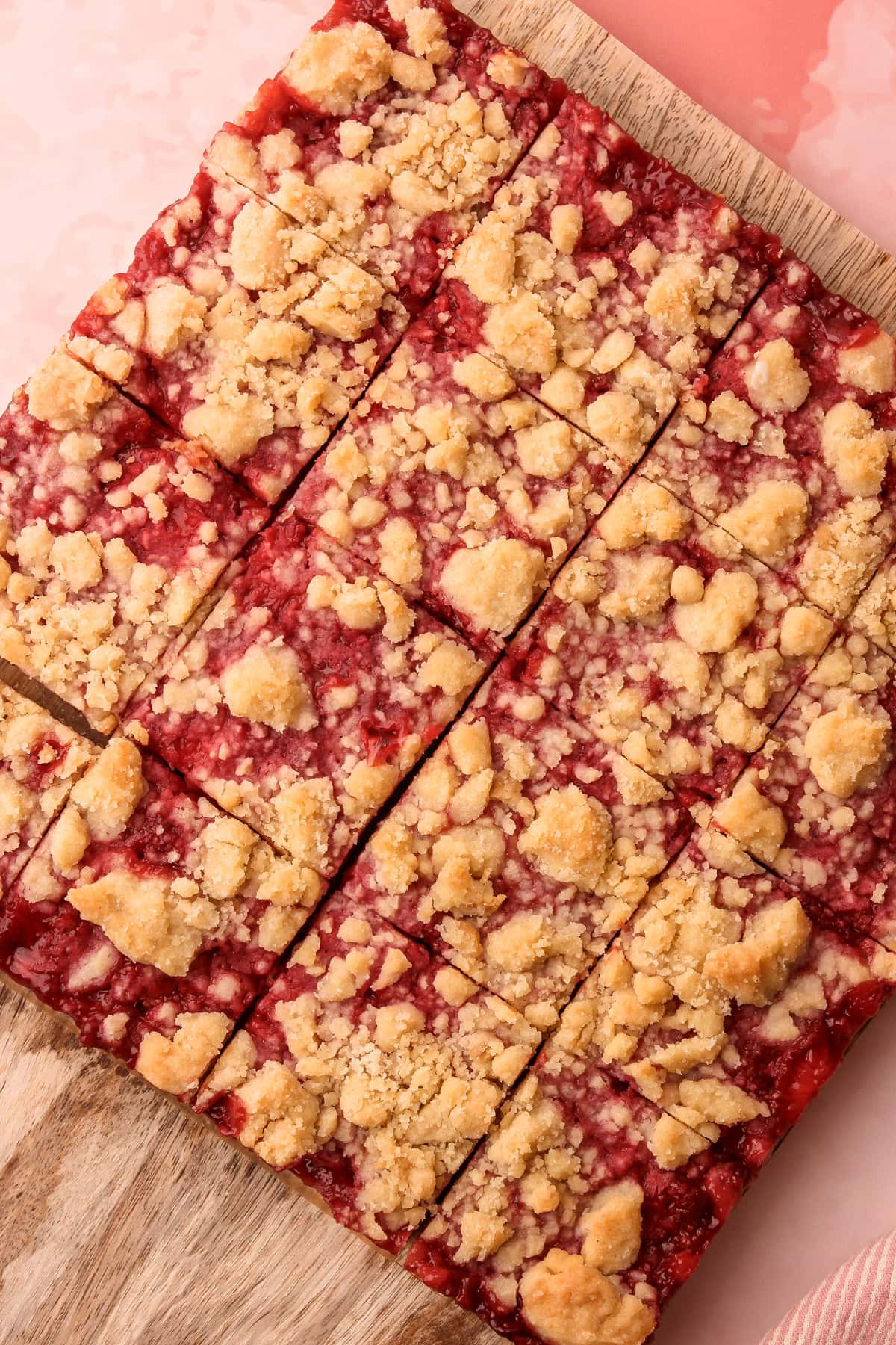 Baked and sliced strawberry crumble bars.