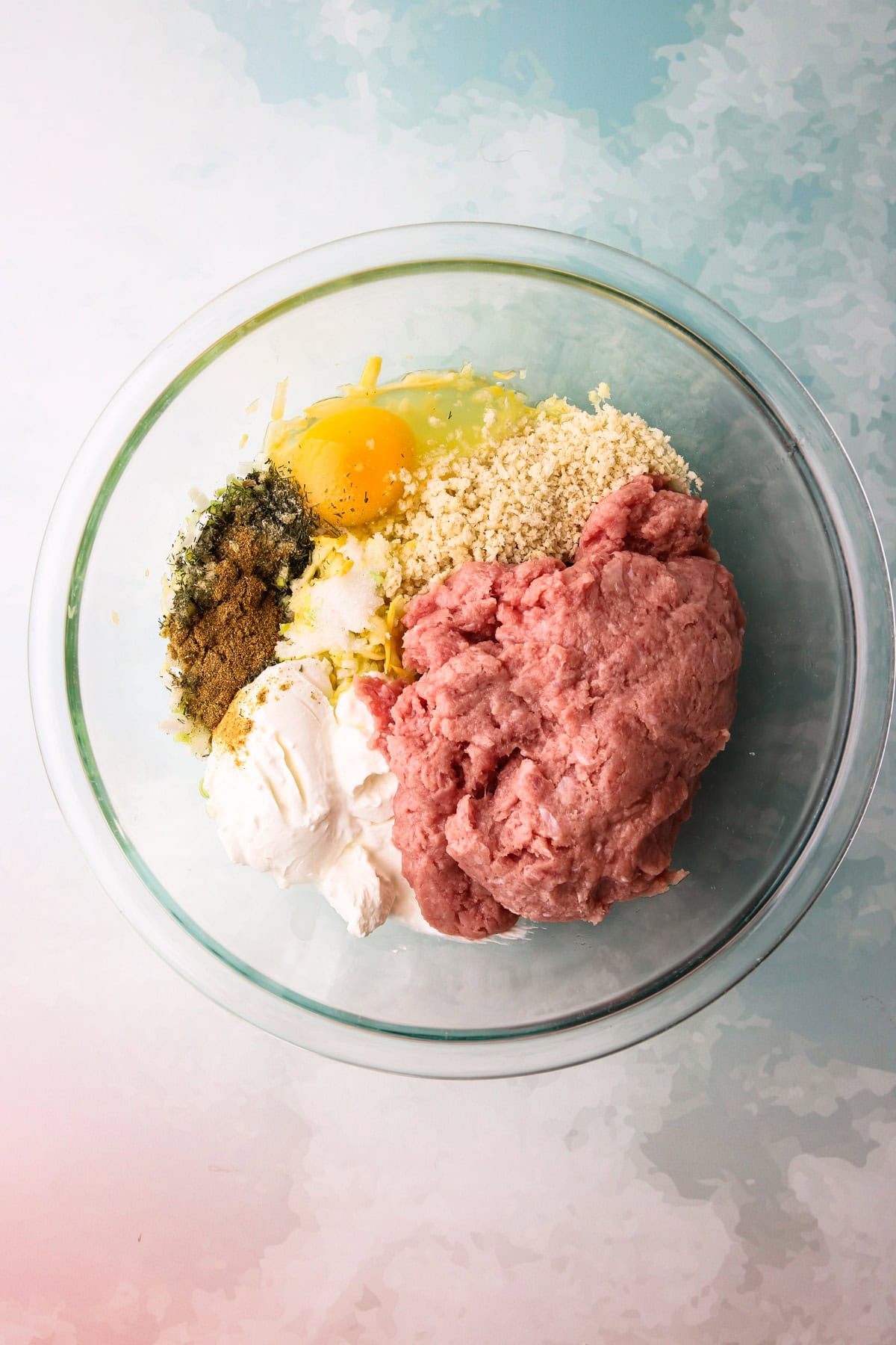 Raw mixture of ingredients to make turkey zucchini meatballs.
