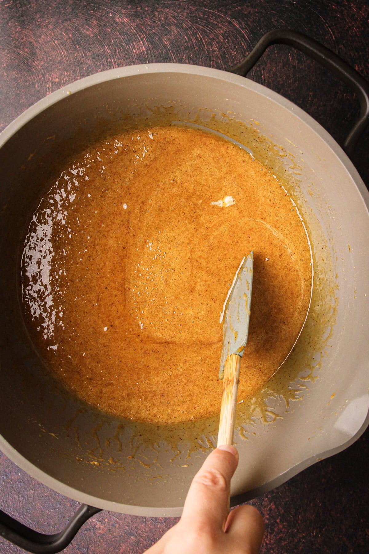 Melted marshmallows, pumpkin and butter to prepare for pumpkin rice crispy treats.
