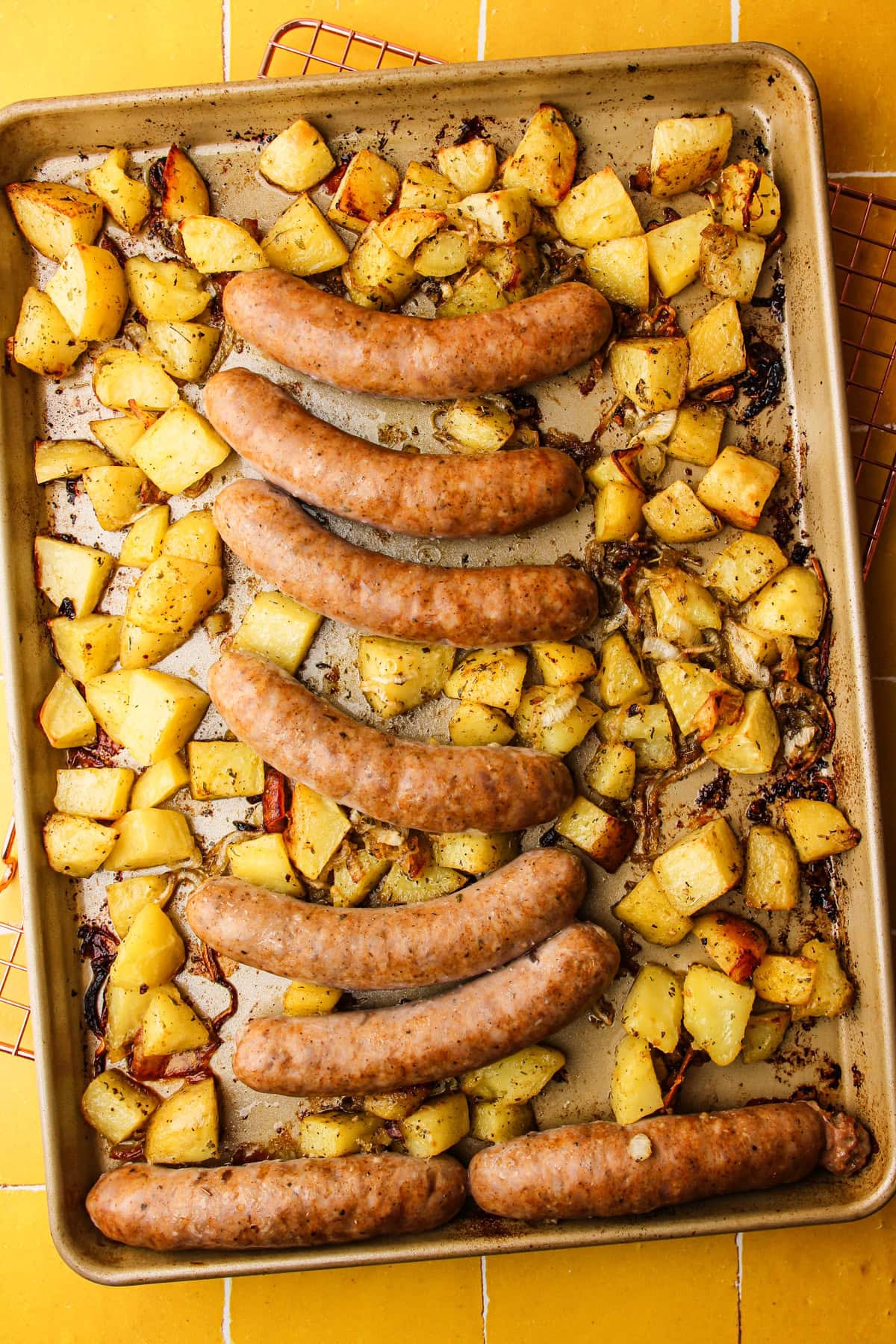 Adding the sausage to the sheet pan.
