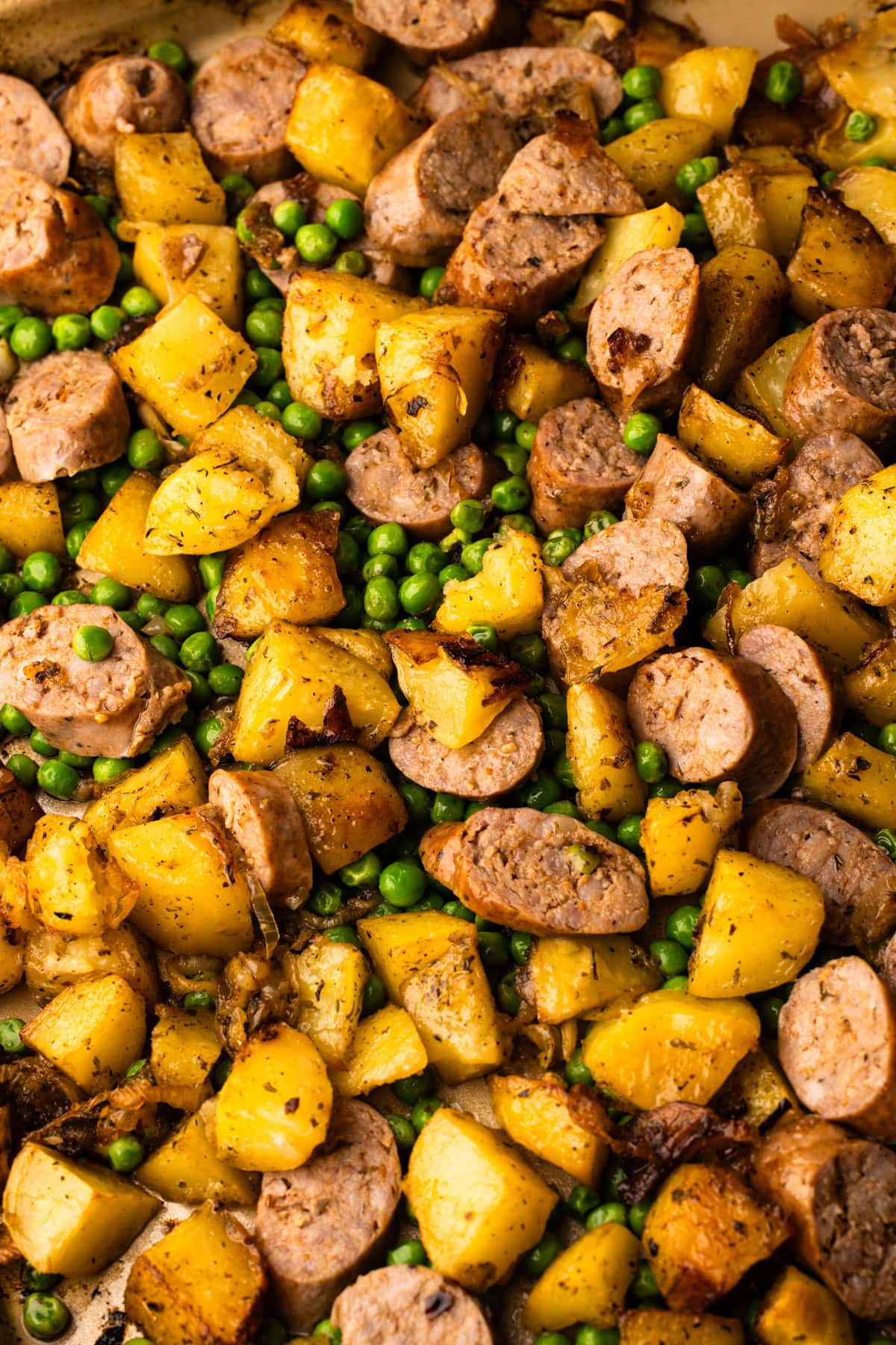 A fully cooked Sheet Pan Sausage and Potato dinner straight from the oven.