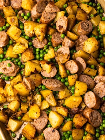 A fully cooked Sheet Pan Sausage and Potato dinner straight from the oven.