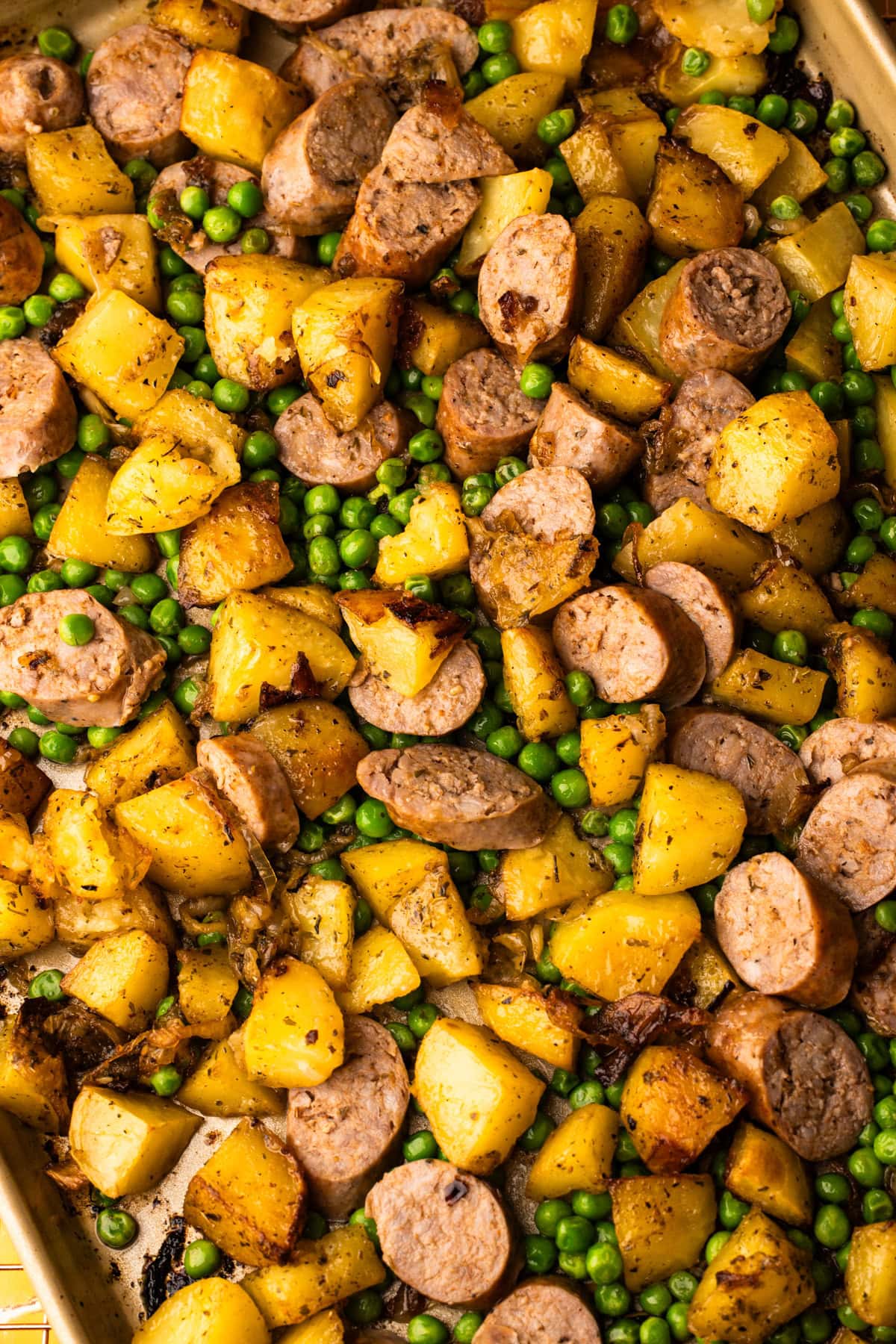 A fully cooked Sheet Pan Sausage and Potato dinner straight from the oven.