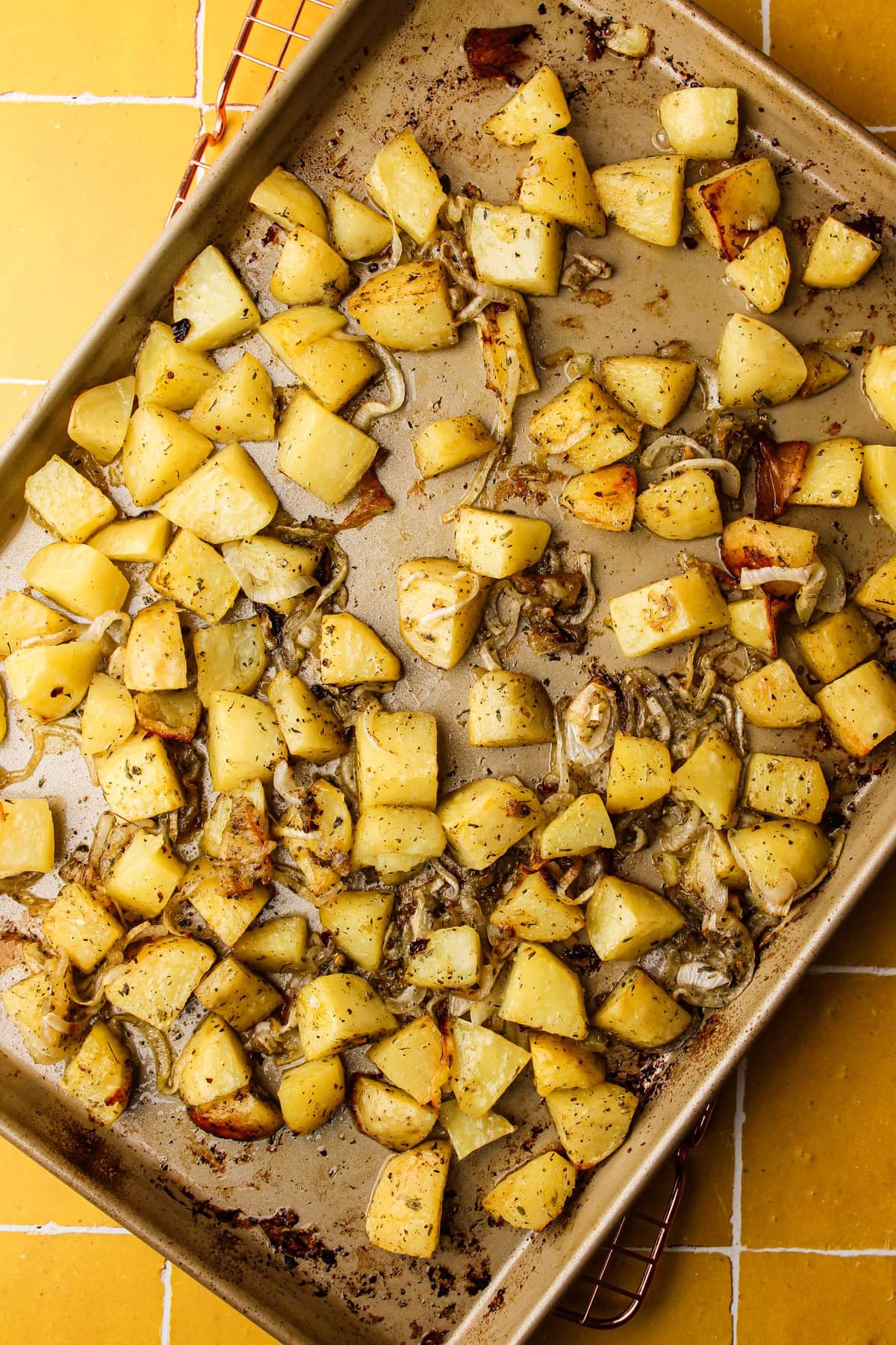 Cooking the potatoes and onions on a sheet pan.