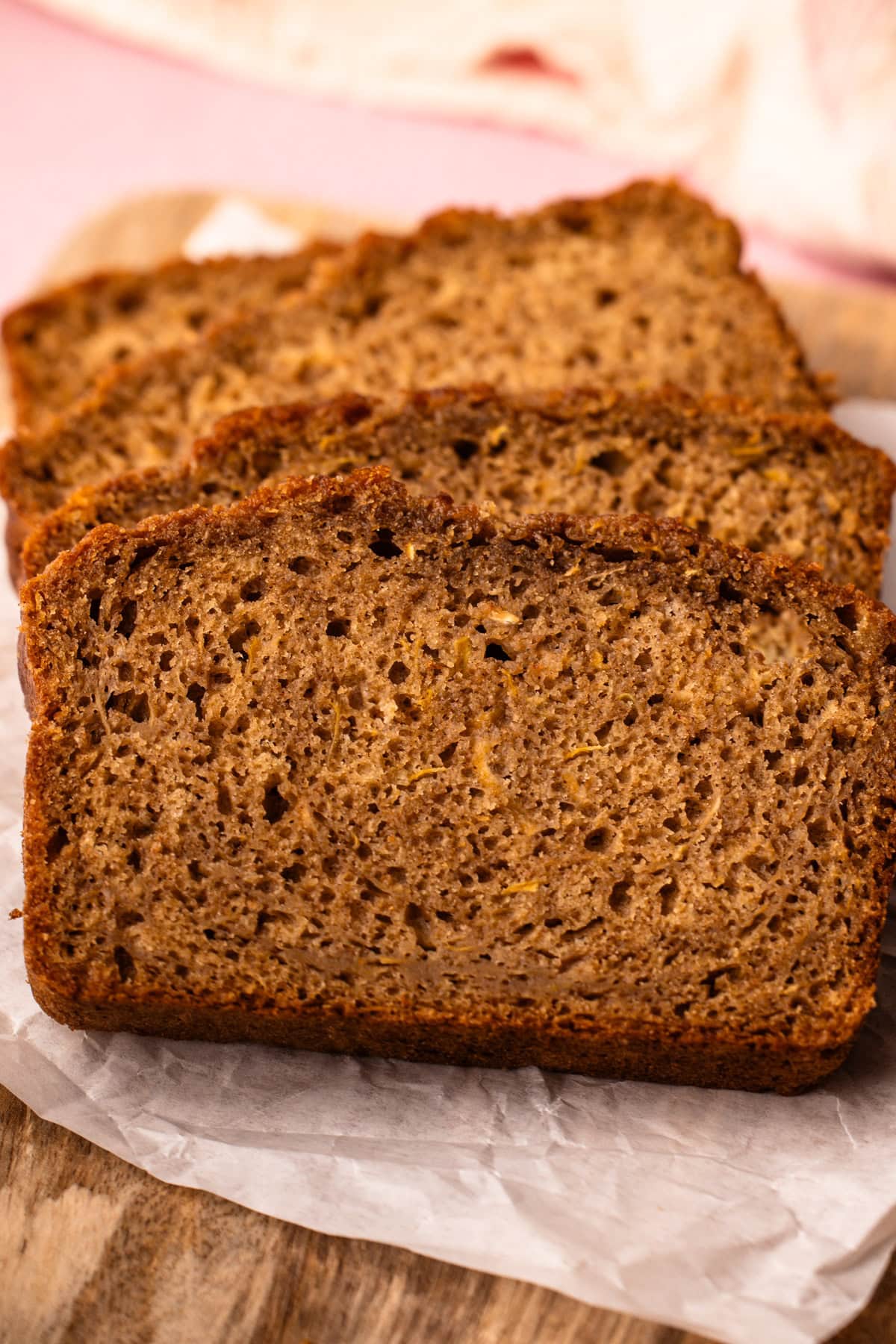 4 slices of zucchini bread on a cutting board.