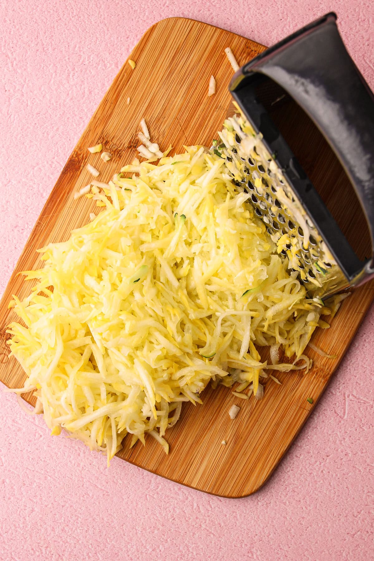 Shredded zucchini on a cutting board.