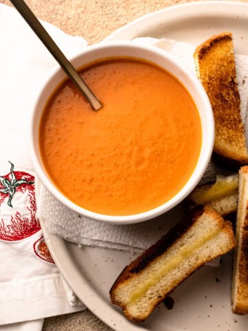 A serving of roasted tomato soup with toast alongside.