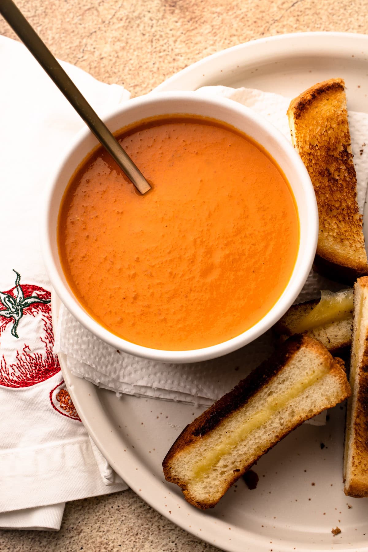 A serving of roasted tomato soup with toast alongside.